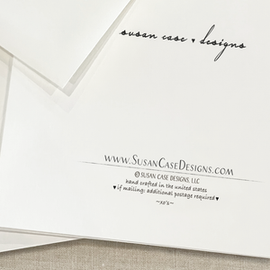 Envelope with 'Susan Case Designs' branding and website address on a textured surface.