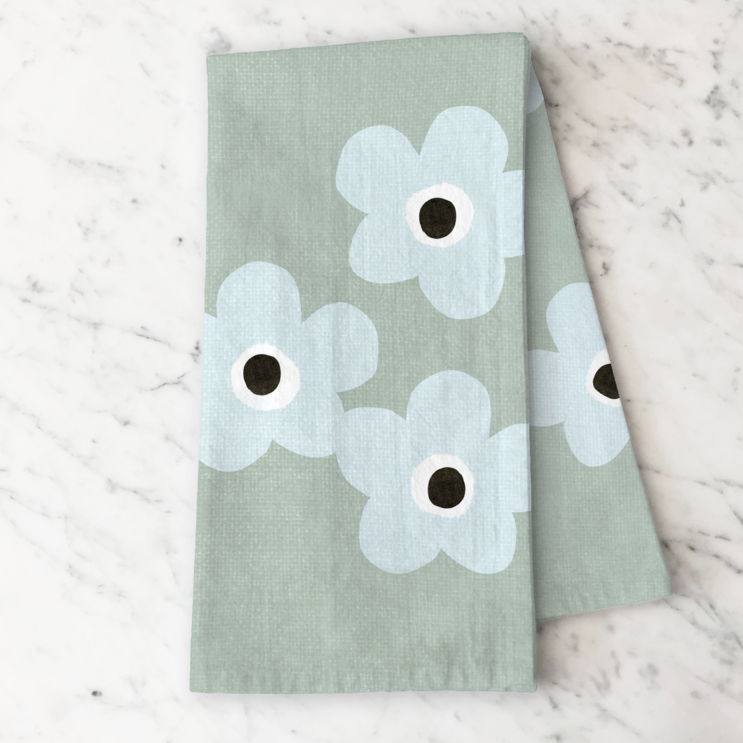 Kitchen tea towel with blue floral patterns on a sage green background
