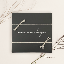 Load image into Gallery viewer, Black box with twine bow and &#39;Susan Case Designs&#39; text on a light background